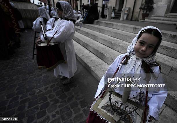 Young faithful carries a crown of thorns prior a Good Friday procession in Civitavecchia, a port town 80km north of Rome on April 2, 2010. Faitful...