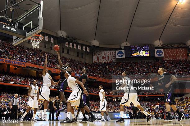 Justin Holiday of the Washington Huskies attempts a shot against the West Virginia Mountaineers during the east regional semifinal of the 2010 NCAA...