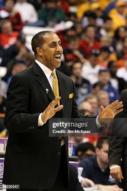 Head coach Lorenzo Romar of the Washington Huskies reacts as he coaches against the West Virginia Mountaineers during the east regional semifinal of...