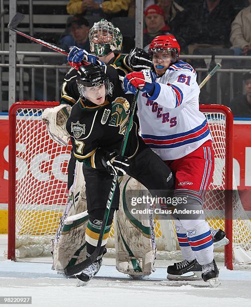 Jeremy Morin of the Kitchener Rangers is held in check by Matt Ashman of the London Knights in the first game of the second round of the 2010...