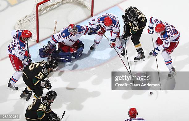 All eyes are on a loose puck in front of Brandon Maxwell of the Kitchener Rangers in the first game of the second round of the 2010 playoffs against...