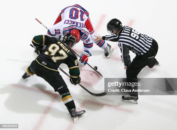Michael Catenacci of the Kitchener Rangers takes a faceoff against Jared Knight of the London Knights in the first game of the second round of the...