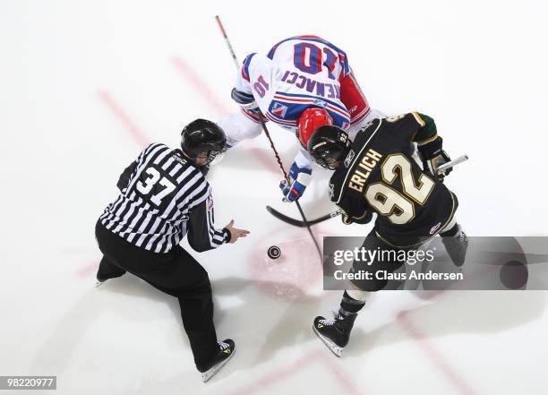 Michael Catenacci of the Kitchener Rangers takes a faceoff against Daniel Erlich of the London Knights in the first game of the second round of the...
