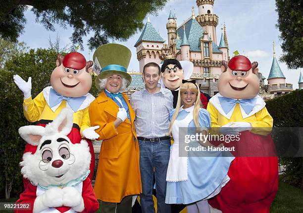 In this handout photo provided by Disney, Paul Reubens meets the cast of "Alice in Wonderland" at Disneyland on April 2, 2010 in Anaheim, California.