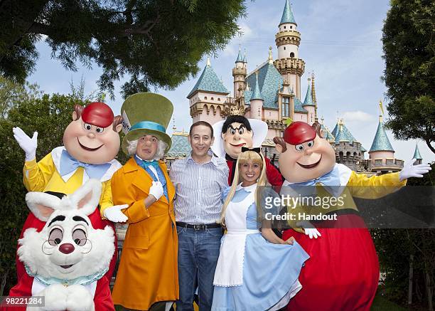 In this handout photo provided by Disney, Paul Reubens meets the cast of "Alice in Wonderland" at Disneyland on April 2, 2010 in Anaheim, California.