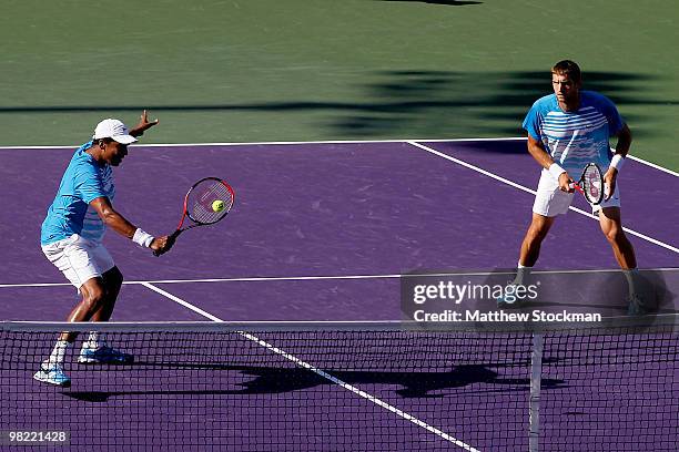 Mahesh Bhupathi of India returns a shot to Mariusz Fyrstenberg and Marcin Matkowski of Poland while playing with Max Mirnyi of Belarus during day...