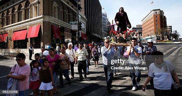 Latino Catholics carry the cross in a Via Crucis procession, also known as walk in the footsteps of Christ, on Good Friday, April 2, 2010 in...