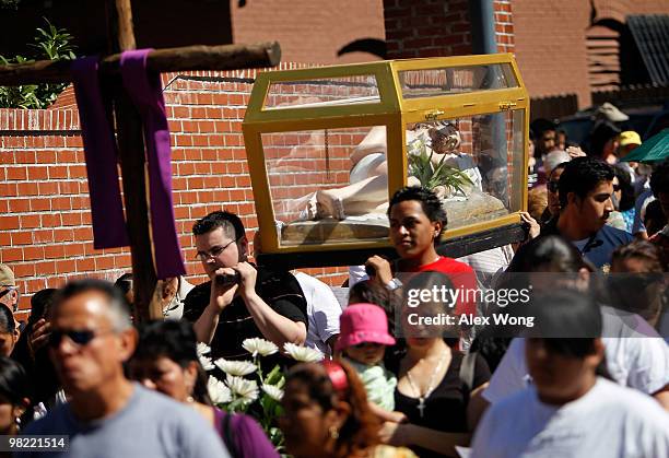 Latino Catholics carry the cross in a Via Crucis procession, also known as walk in the footsteps of Christ, on Good Friday, April 2, 2010 in...