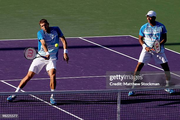 Max Mirnyi of Belarus returns a shot to Mariusz Fyrstenberg and Marcin Matkowski of Poland while playing with Mahesh Bhupathi of India during day...