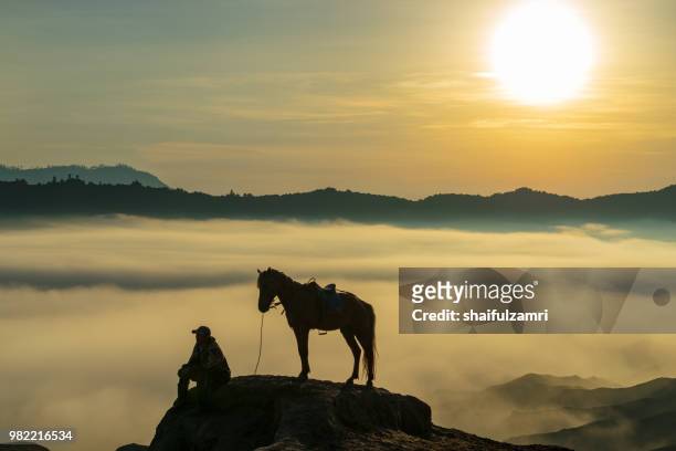 unidentified local people or bromo horseman at the mountainside of mount bromo, semeru, tengger national park, east java of indonesia. - shaifulzamri stock pictures, royalty-free photos & images