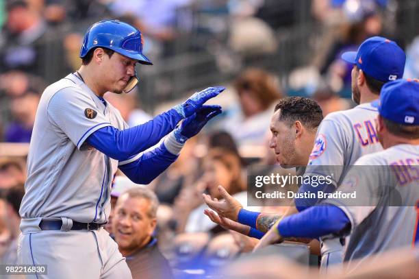 Wilmer Flores of the New York Mets celebrates a fourth inning solo homerun against the Colorado Rockies at Coors Field on June 18, 2018 in Denver,...