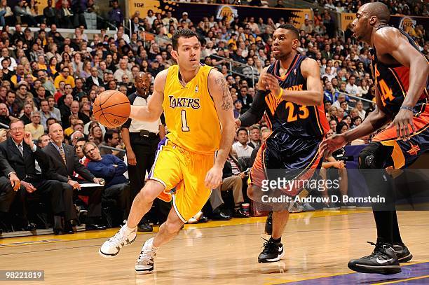 Jordan Farmar of the Los Angeles Lakers drives to the basket past C.J. Watson and Anthony Tolliver of the Golden State Warriors during the game on...