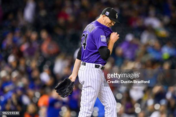 Jeff Hoffman of the Colorado Rockies reacts after issuing a bases-loaded walk in the ninth inning of a game against the New York Mets at Coors Field...