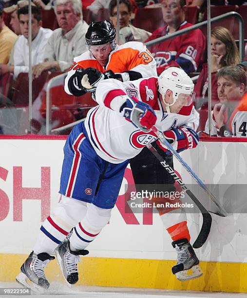 Darroll Powe of the Philadelphia Flyers and Andrei Markov of the Montreal Canadiens collide along the boards on April 2, 2010 at the Wachovia Center...