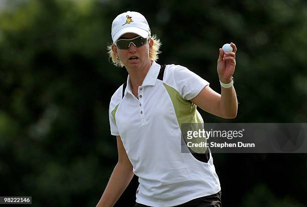 Karrie Webb of Australia holds up her ball after making a birdie putt on the 15th hole during the second round of the Kraft Nabisco Championship at...