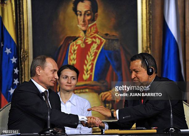 Venezuelan President Hugo Chavez shakes hands with Russian Prime Minister Vladimir Putin, during his visit to Miraflores presidential palace in...