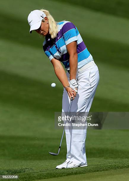 Suzann Pettersen of Norway chips onto the green on the 11th hole during the second round of the Kraft Nabisco Championship at Mission Hills Country...