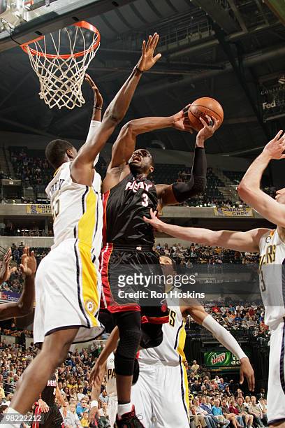 Dwyane Wade of the Miami Heat battles Roy Hibbert of the Indiana Pacers at Conseco Fieldhouse on April 2, 2010 in Indianapolis, Indiana. NOTE TO...