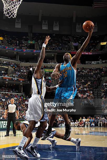 Julian Wright of the New Orleans Hornets attempts a shot over DeMarre Carroll of the Memphis Grizzlies on April 02, 2010 at FedExForum in Memphis,...