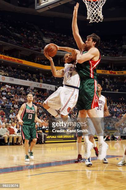 Andrew Bogut of the Milwaukee Bucks blocks against D.J. Augustin of the Charlotte Bobcats on April 2, 2010 at the Time Warner Cable Arena in...