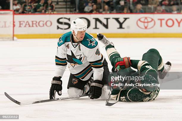Andrew Brunette of the Minnesota Wild is checked by Rob Blake of the San Jose Sharks during the game at the Xcel Energy Center on April 2, 2010 in...