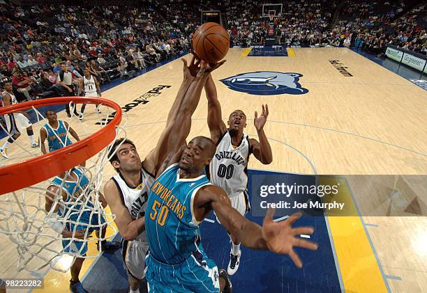 Hamed Haddadi and Darrell Arthur of the Memphis Grizzlies fight for a rebound against Emeka Okafor of the New Orleans Hornets on April 02, 2010 at...