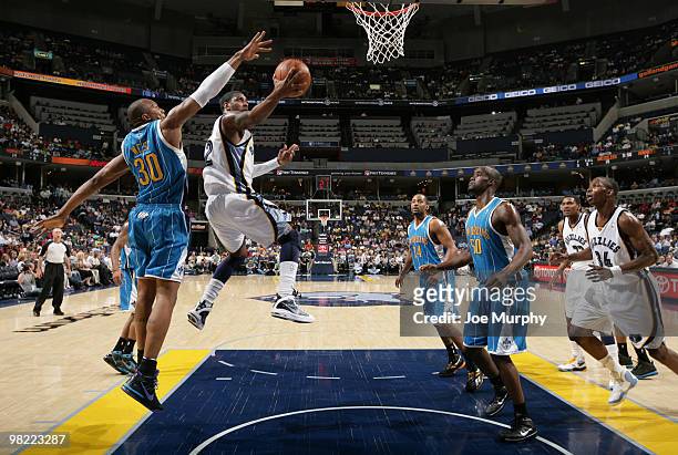 Mayo of the Memphis Grizzlies attempts the scoop shot around David West of the New Orleans Hornets on April 02, 2010 at FedExForum in Memphis,...
