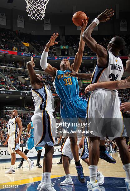 David West of the New Orleans Hornets shoots against Hasheem Thabeet of the Memphis Grizzlies on April 02, 2010 at FedExForum in Memphis, Tennessee....