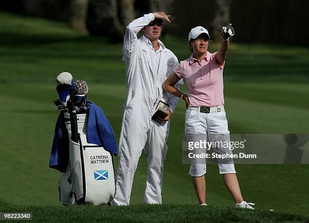 Catriona Matthew of Scotland and her husband/caddie Graeme line up her second shot on the 15th hole during the second round of the Kraft Nabisco...