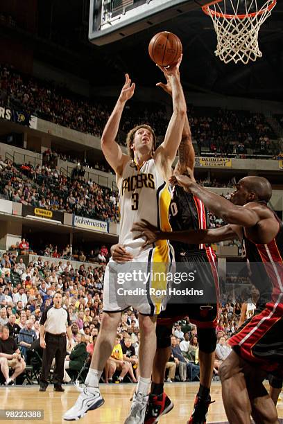 Troy Murphy of the Indiana Pacers shoots over Udonis Haslem and Joel Anthony of the Miami Heat at Conseco Fieldhouse on April 2, 2010 in...