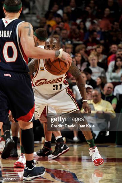 Jawad Williams of the Cleveland Cavaliers focuses on the his opponent Mike Bibby of the Atlanta Hawks on April 2, 2010 at The Quicken Loans Arena in...