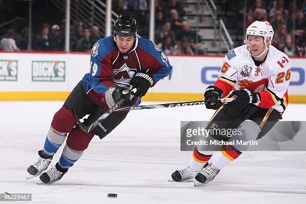 Brandon Yip of the Colorado Avalanche skates with the puck against David Moss of the Calgary Flames at the Pepsi Center on April 2, 2010 in Denver,...