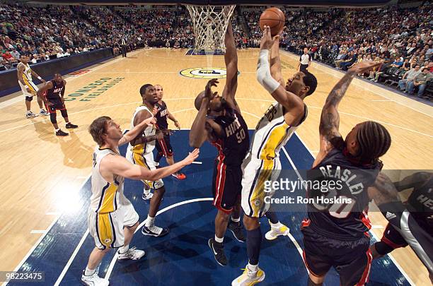 Danny Granger of the Indiana Pacers battles Michael Beasley and Joel Anthony of the Miami Heat at Conseco Fieldhouse on April 2, 2010 in...