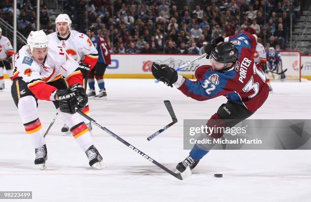 Kevin Porter of the Colorado Avalanche breaks his stick while shooting against Jay Bouwmeester ofthe Calgary Flames at the Pepsi Center on April 2,...