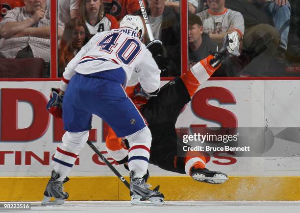 Maxim Lapierre of the Montreal Canadiens checks Darroll Powe of the Philadelphia Flyers to the ice at the Wachovia Center on April 2, 2010 in...