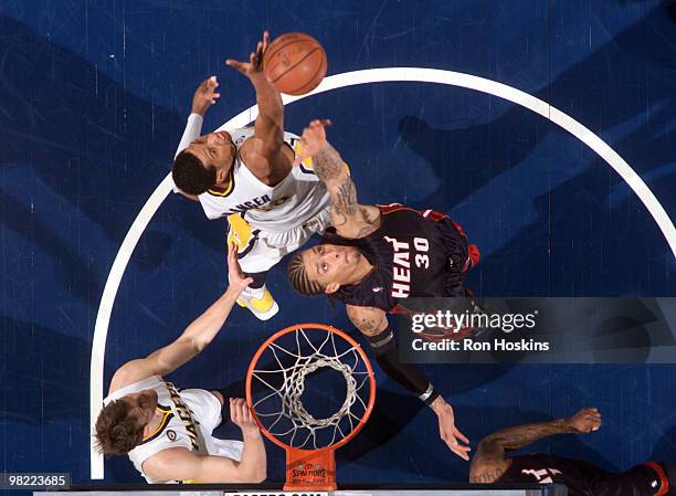 Michael Beasley of the Miami Heat battles Danny Granger and Troy Murphy of the Indiana Pacers at Conseco Fieldhouse on April 2, 2010 in Indianapolis,...