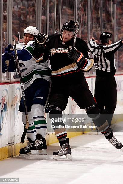 Bobby Ryan of the Anaheim Ducks checks Kyle Wellwood of the Vancouver Canucks into the boards during the game on April 2, 2010 at Honda Center in...