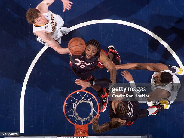 Udonis Haslem of the Miami Heat battles Troy Murphy and Danny Granger of the Indiana Pacers at Conseco Fieldhouse on April 2, 2010 in Indianapolis,...