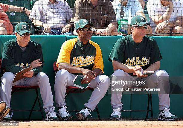 Coaches Curt Young, Tye Waller and Bob Geren of the Oakland Athletics during the MLB spring training game against the Chicago Cubs at HoHoKam Park on...