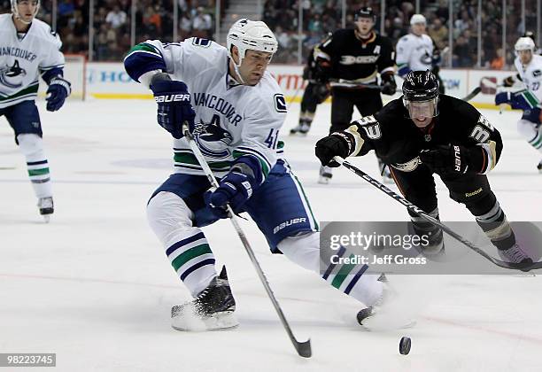 Andrew Alberts of the Vancouver Canucks is pursued by Jason Blake of the Anaheim Ducks for the puck in the first period at the Honda Center on April...