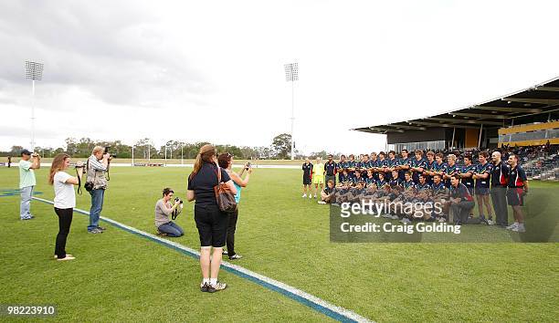 Players from the AIS AFL Academy Squad pose for a team photo before the start of the trial match between the AIS AFL Academy Squad and the Sydney...