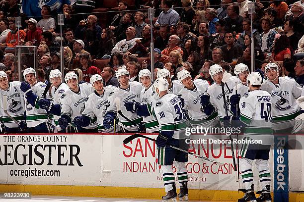 Michael Grabner of the Vancouver Canucks high fives teammates after his second period goal against the Anaheim Ducks during the game on April 2, 2010...