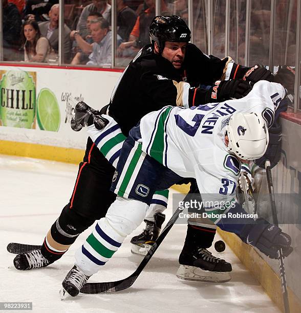 Aaron Ward of the Anaheim Ducks checks Rick Rypien of the Vancouver Canucks into the boards during the game on April 2, 2010 at Honda Center in...