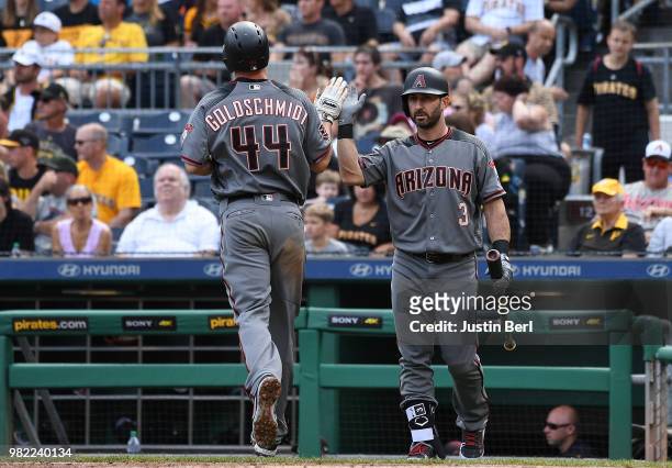 Paul Goldschmidt of the Arizona Diamondbacks high fives with Daniel Descalso after coming around to score on an RBI double by David Peralta in the...