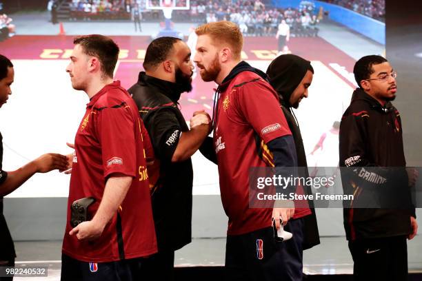 Of Cavs Legion Gaming Club shakes hands with I 24k Dropoff I of the Heat Check Gaming on June 23, 2018 at the NBA 2K League Studio Powered by Intel...