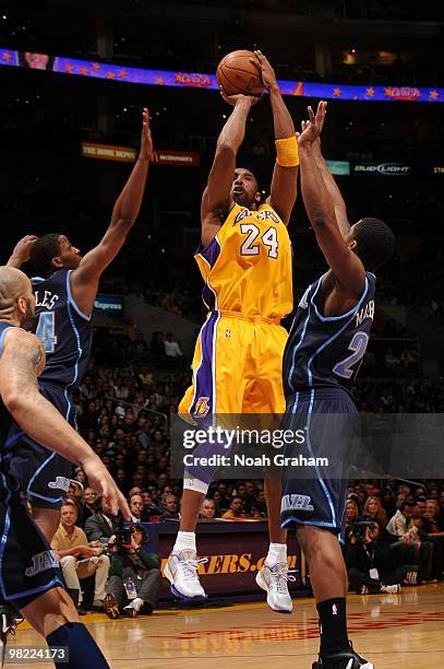 Kobe Bryant of the Los Angeles Lakers shoots between C.J. Miles and Paul Millsap of the Utah Jazz at Staples Center on April 2, 2010 in Los Angeles,...