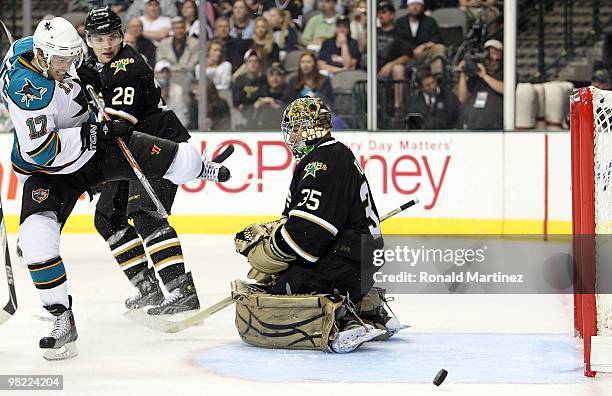 Center Torrey Mitchell of the San Jose Sharks takes a shot against Marty Turco of the Dallas Stars at American Airlines Center on March 31, 2010 in...