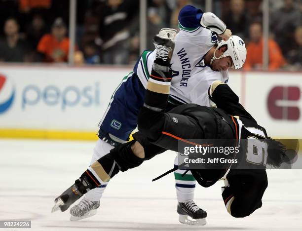 Darcy Hordichuk of the Vancouver Canucks throws George Parros of the Anaheim Ducks to the ground during a fight in the second period at the Honda...