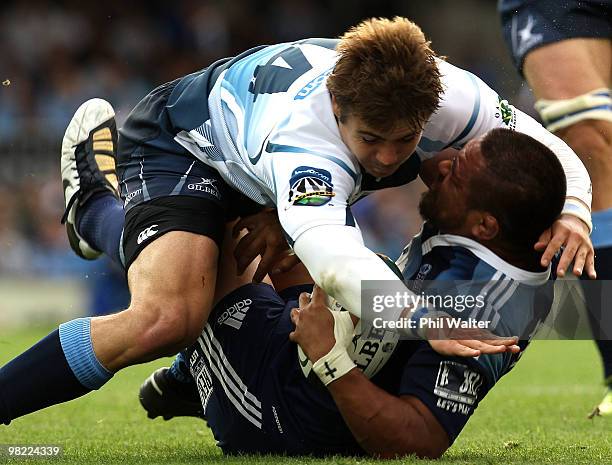 Gerhard van den Heever of the Bulls tackles Keven Mealamu of the Blues to the ground during the round eight Super 14 match between the Blues and the...