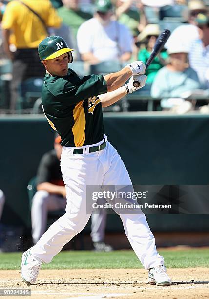 Mark Ellis of the Oakland Athletics bats against the San Francisco Giants during the MLB spring training game at Phoenix Municipal Stadium on March...